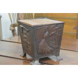 An Arts & Crafts hammered copper and brass mounted two handled coal bucket with embossed stylised