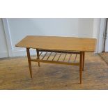 A 1970s formica topped rectangular coffee table, with upswept ends, on turned tapered supports (h.