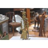 A novelty Dartmoor Pixie cast brass companion set comprising poker, brush, tongs and shovel,