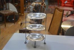 An Epns three tier cakestand with original scalloped serving plates, on pad feet (h.42cm d.22cm)