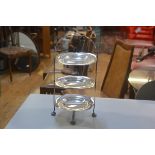 An Epns three tier cakestand with original scalloped serving plates, on pad feet (h.42cm d.22cm)