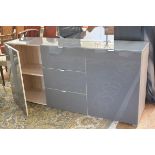 A modern grey toughened glass topped and fronted oak veneered side cabinet fitted three centre