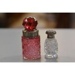 A Birmingham silver cranberry glass faceted perfume bottle with silver collar and faceted stopper,