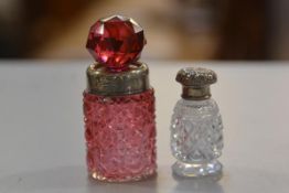 A Birmingham silver cranberry glass faceted perfume bottle with silver collar and faceted stopper,