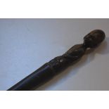 An African carved light wood seated figure walking stick (l.91cm)
