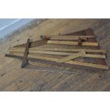 A collection of early 20thc yardsticks (3), a T square, a folding yard stick, a folding measure, a