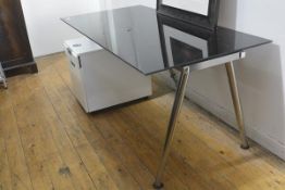 An Ikea black toughened glass rectangular adjustable office desk complete with laminated two