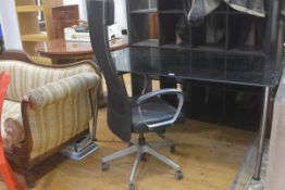 An Ikea black plate glass top adjustable desk complete with Ikea Executive style anodised metal