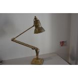 A 1930s/40s anodised metal adjustable anglepoise lamp with painted marbled finish, raised on stepped