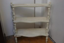 A 19thc French three tier stepped etagere raised on turned supports with distressed cream and