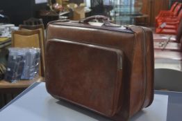 A vintage tan hide folding carry on case with zipper side pockets and handle to top (h. 46cm x l.