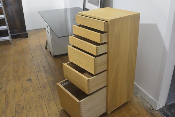 A solid oak tallboy chest, the square top with moulded edge above three slim and three graduated