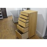A solid oak tallboy chest, the square top with moulded edge above three slim and three graduated