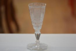 A 19thc German octagonal goblet with engraved crest and motto, on faceted stem and spreading