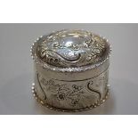 A Victorian London silver circular dish and cover with chased cartouche and C scroll ribbon
