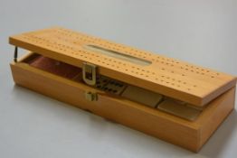 A modern pine gentleman's brass mounted games compendium, complete with dominoes, cribbage board,