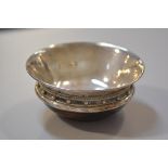 An ash treen bowl in the Arts and Crafts style with Chester silver hammered lining and rim with bead