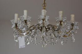 A crystal eleven branch pendant light fitting with faceted thumb cut cups, with swags and faceted