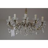 A crystal eleven branch pendant light fitting with faceted thumb cut cups, with swags and faceted