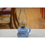 A 19thc blue glass bedchamber oil lamp with handpainted floral design, complete with glass funnel (