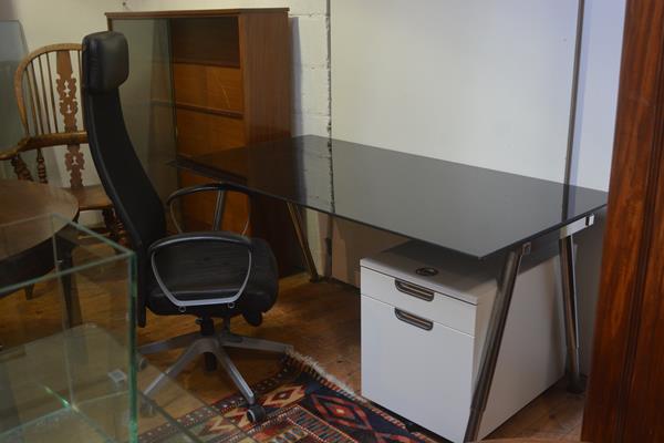 An Ikea black toughened glass rectangular adjustable office desk complete with two drawer soft