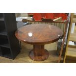 An Italian Connection high gloss walnut veneered and brass inlaid circular extending dining table,