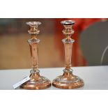 A pair of 19thc copper and pewter mounted baluster stem candlesticks on circular moulded bases, with