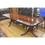 A reproduction mahogany twin pedestal extending dining table, the rectangular top with rounded
