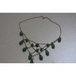 A white metal spider's web necklace mounted with jadeite pear drop and circular beads (clasp a/f)