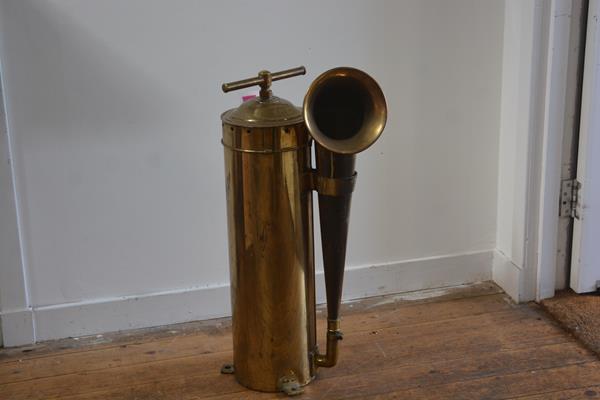 A brass marine foghorn, the domed cylindrical case with t-bar handle and side-mounted horn. 80cm