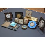 A group of seven vintage travel clocks, some with engine-turned enamel cases (losses); together with