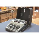 A vintage Olympia portable typewriter, cased.