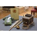A group including a Victorian sprung service bell with brass push-button, a vintage green telephone,