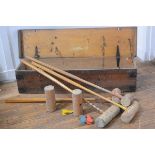 An early 20th century croquet set (incomplete), with four mallets, in its original pine box.