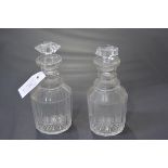 A pair of Regency triple-ring neck cut-glass decanters. 21cm