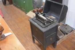 An American Dictaphone Co. shaving machine, early 20th century, in a dome-topped cabinet. 76cm by