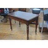 A Victorian mahogany side table, the rounded rectangular top above a plain frieze, raised on ring-