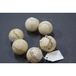 A group of six small hand-stitched leather balls, each possibly a feathery, 19th century. Diameter