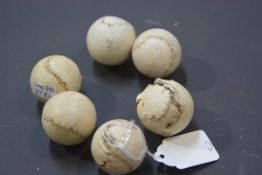 A group of six small hand-stitched leather balls, each possibly a feathery, 19th century. Diameter