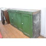 A 19th century green-painted shallow side cabinet, the rectangular top over two pairs of panelled