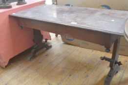 A Victorian mahogany library table, the rectangular moulded top raised on shaped trestles (stretcher