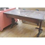 A Victorian mahogany library table, the rectangular moulded top raised on shaped trestles (stretcher