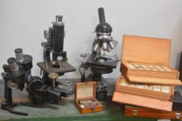 A group of four assorted 20th century microscopes together with a number of slide boxes. (9)