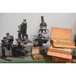 A group of four assorted 20th century microscopes together with a number of slide boxes. (9)