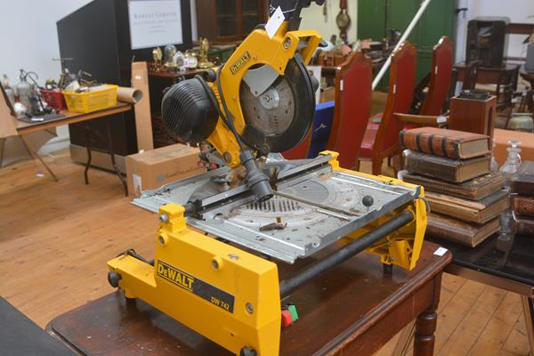 A table top circular saw, DeWalt model DW 742, with triple round pin transformer cable fitting