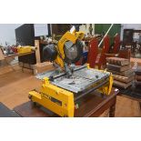 A table top circular saw, DeWalt model DW 742, with triple round pin transformer cable fitting