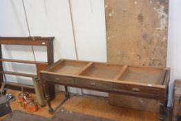 A large Edwardian mahogany side table, the top formed from a door, over three frieze drawers, raised