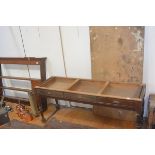 A large Edwardian mahogany side table, the top formed from a door, over three frieze drawers, raised