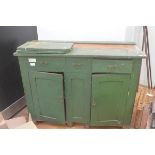 A green-painted pine country side cabinet, c. 1900, the rectangular top over three frieze drawers