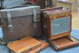 An E. & T. Underwood "The President" mahogany tailboard camera, c. 8" square, lacking lens, in a